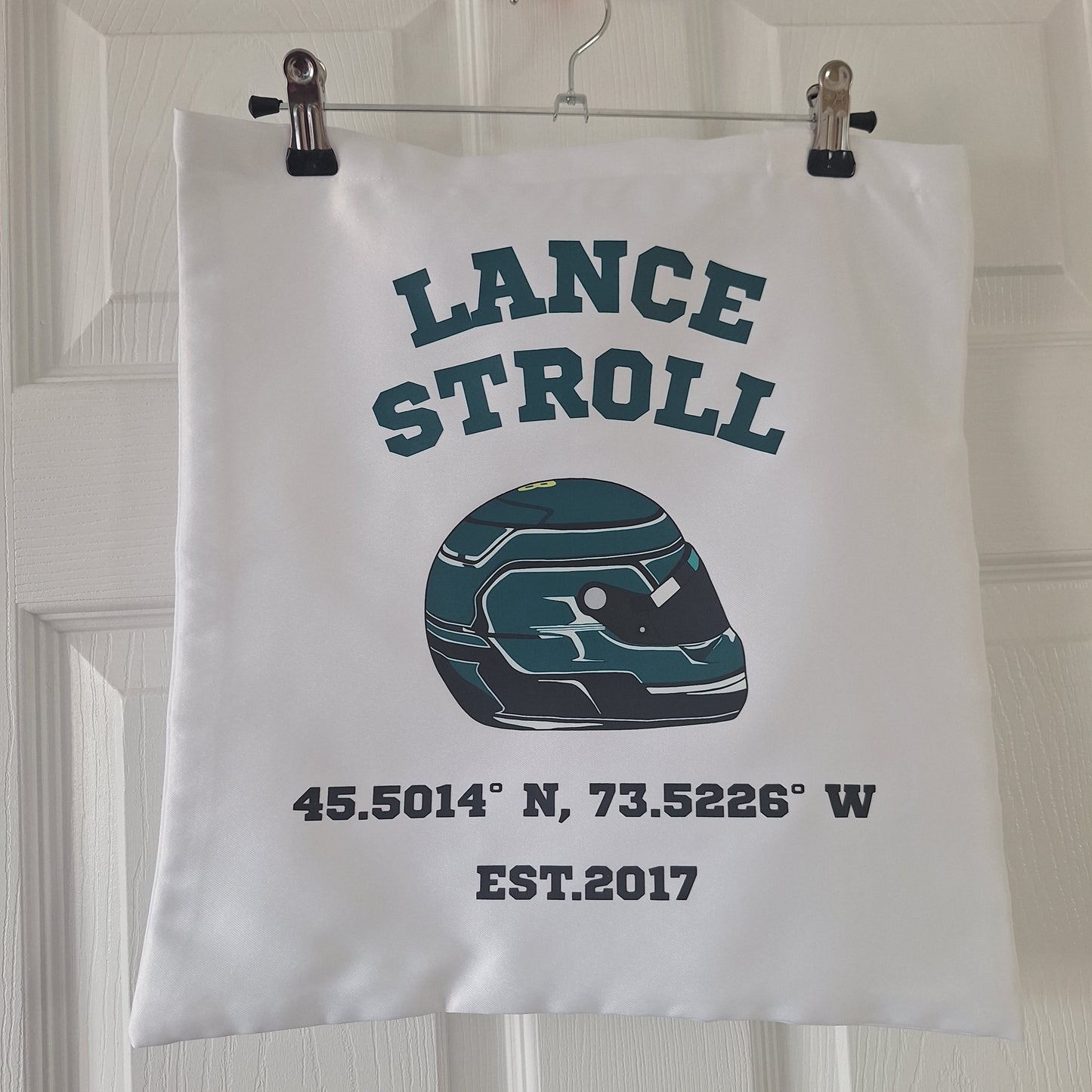 Lance Stroll Formula 1 helmet tote bag featuring helmet graphic, coordinates, and varsity-style typography on a white reusable tote bag.