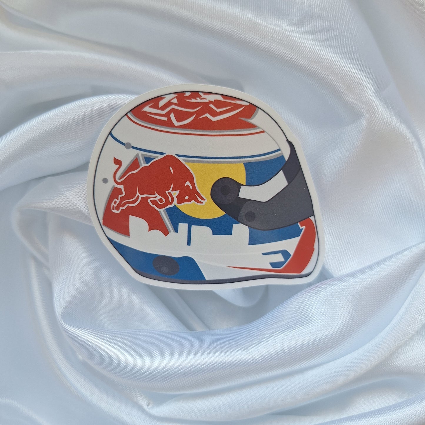 Max Verstappen 2026 Formula 1 helmet sticker featuring a red, white and blue racing helmet design with Red Bull-inspired graphics and a dark visor on a white background.