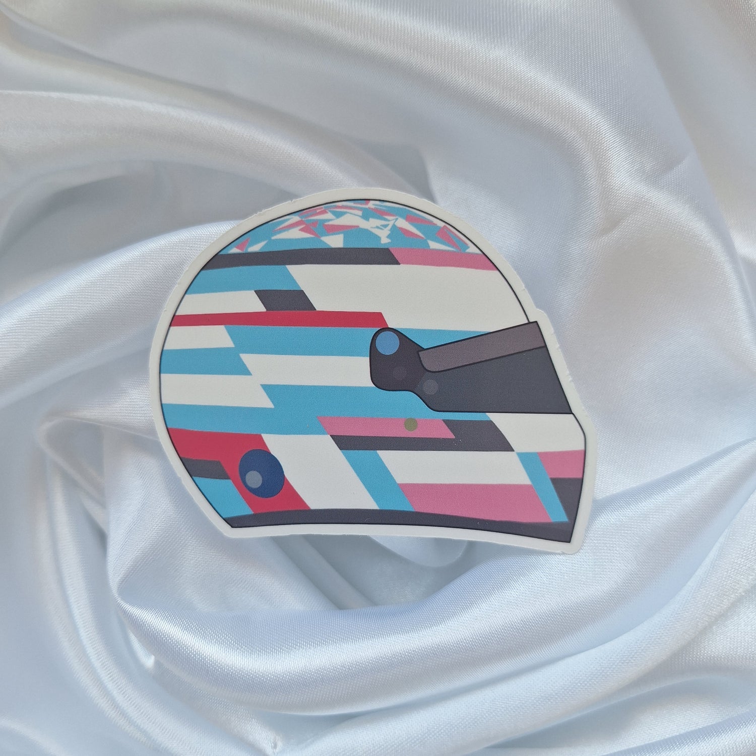 Franco Colapinto 2026 Formula 1 helmet sticker featuring a blue, white and pink geometric racing helmet design with a dark visor on a white background.