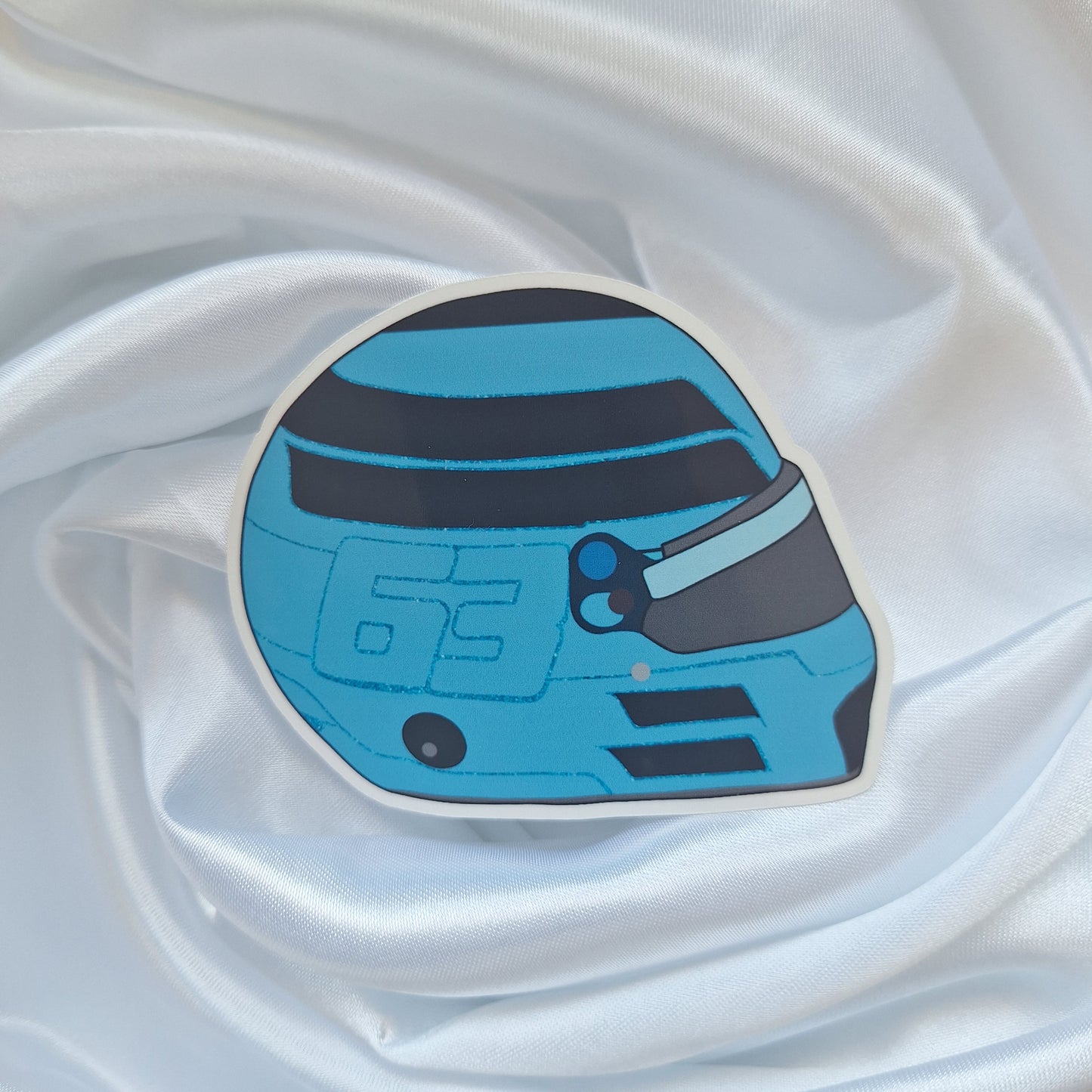 George Russell 2026 Formula 1 helmet sticker featuring a vibrant blue racing helmet design with black visor detailing and the number 63 on a white background.