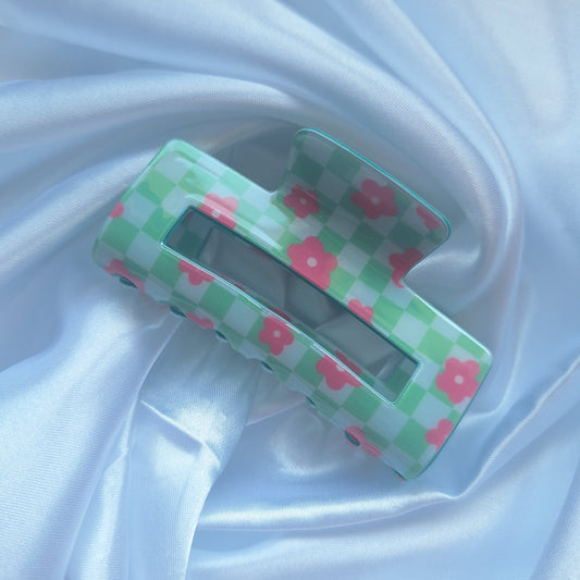 Green gingham hair claw clip with pink floral details and checkered racing pattern