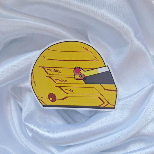 Lewis Hamilton 2026 Formula 1 helmet sticker featuring a vibrant yellow racing helmet design with red accents, star details, and a dark visor on a white background.