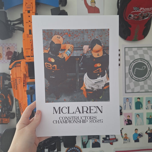 McLaren Constructors' Championship 2025 Formula 1 print featuring Lando Norris and Oscar Piastri celebrating the team's title victory.