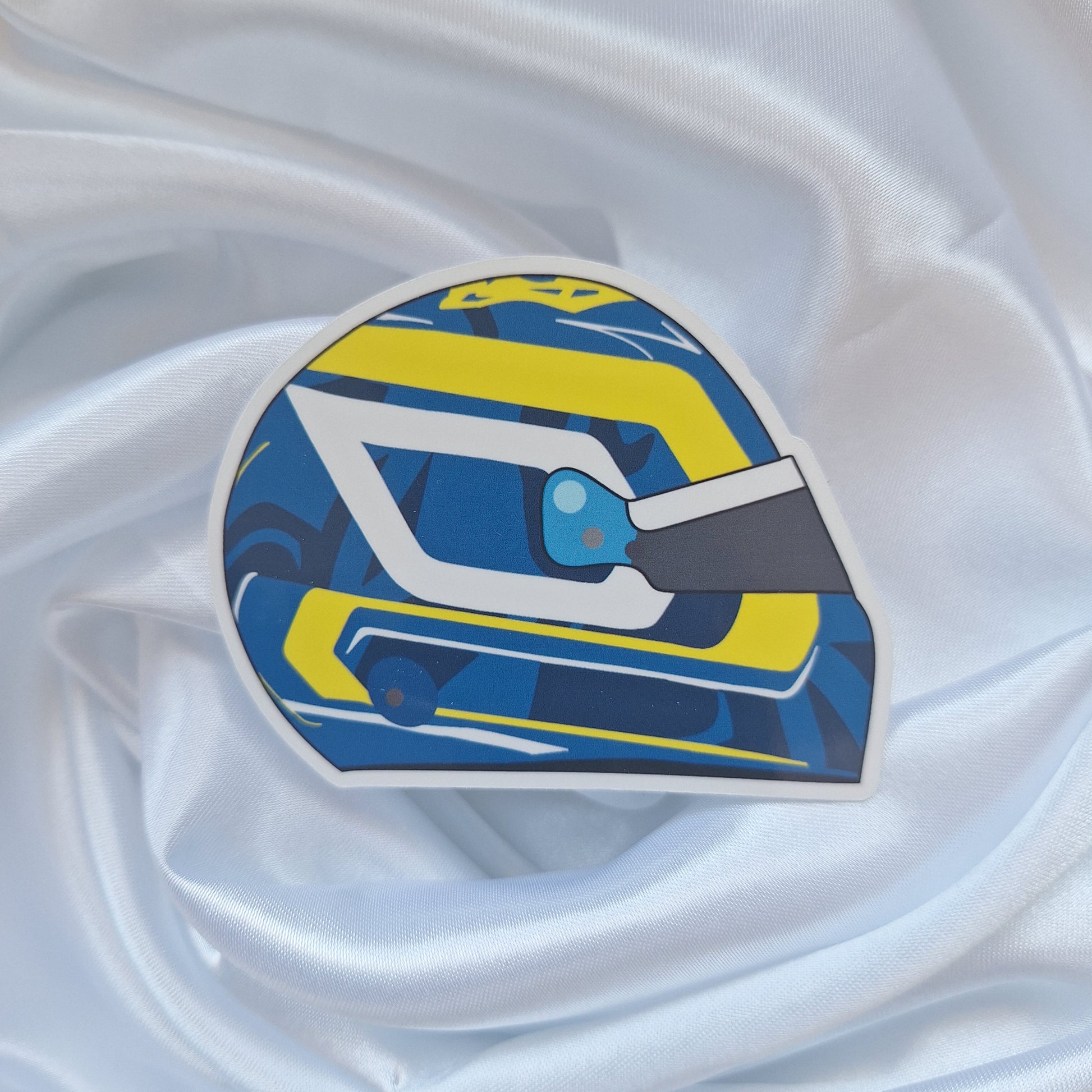 Oliver Bearman 2026 Formula 1 helmet sticker featuring a blue, yellow and white racing helmet design with bold geometric graphics and a dark visor on a white background.