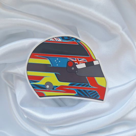 Oscar Piastri 2026 Formula 1 helmet sticker featuring a colourful racing helmet design with papaya orange, yellow, blue and black accents inspired by the Australian McLaren driver.